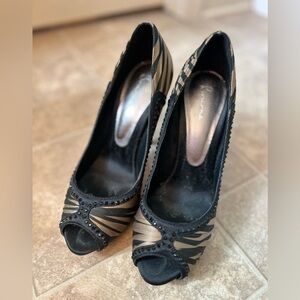 Women’s Bourne Black and Gold Peep-Toe Heels with black crystal embellishment.
